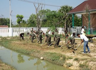US Marines battle the heat while tilling an area behind the Child Protection and Development Center in Huay Yai to be used as a vegetable garden.